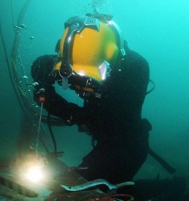 Commercial diver performing wet underwater welding.