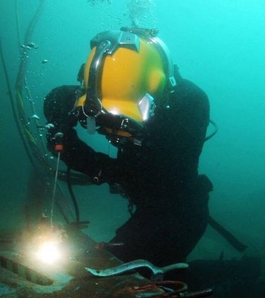 Commercial diver performing wet underwater welding.