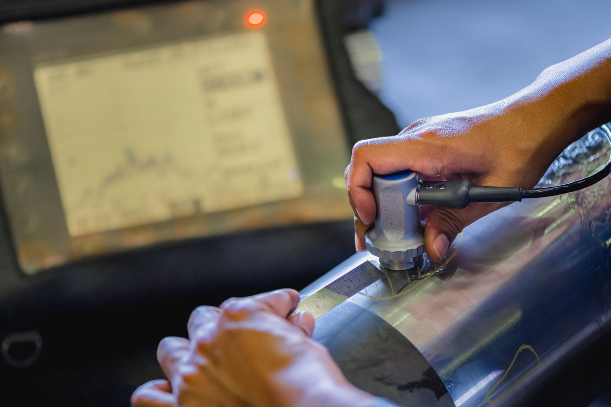 Close-up of an ultrasonic testing machine being used on a piece of metal